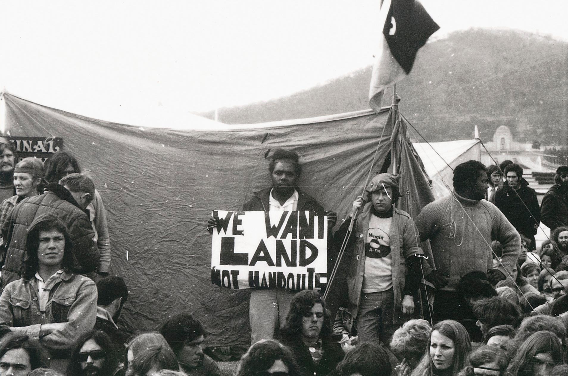 Demonstration with ’We want land not handouts‘ placard at Parliament House, Canberra, 30 July 1972.