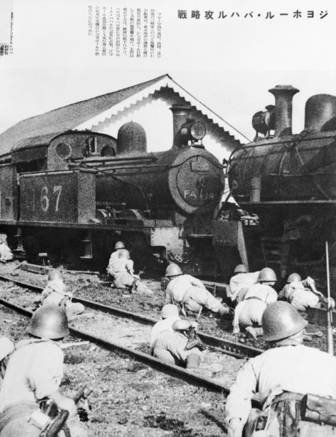 Japanese troops take cover behind steam engines in Johore, Malaya
