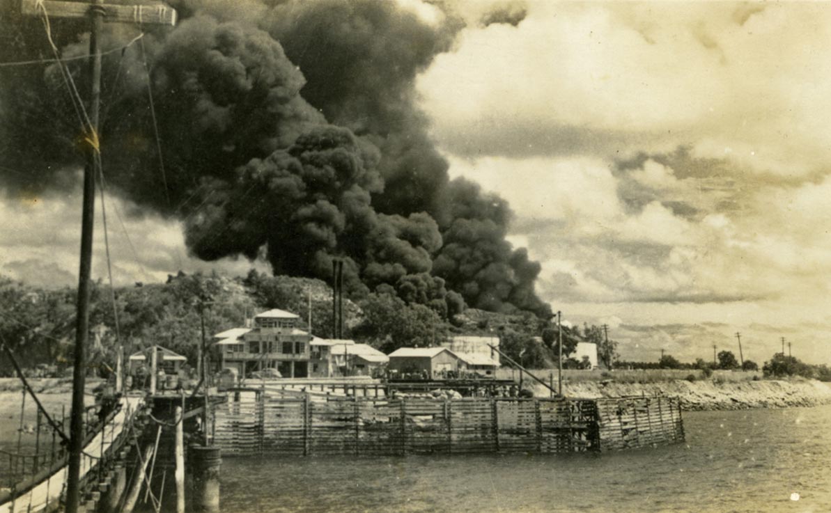 Oil tanks in Darwin on fire after bombing, 1942.