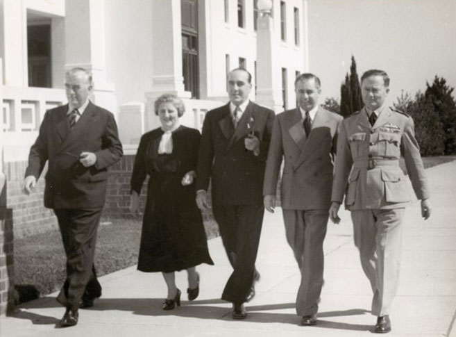 Robert Menzies, Dame Enid Lyons, Eric Harrison, Harold Holt and air force personnel outside Parliament House, Canberra, about 1946.