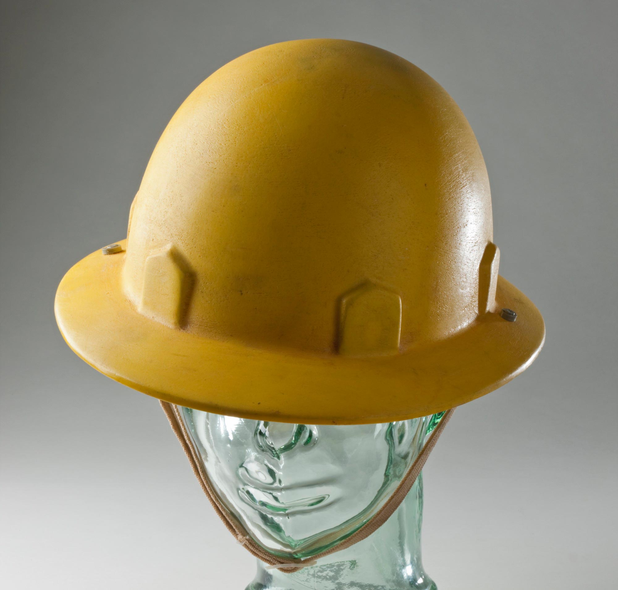 Moulded yellow plastic hard hat used by a worker on the Snowy Mountains Hydro-Electric Scheme.