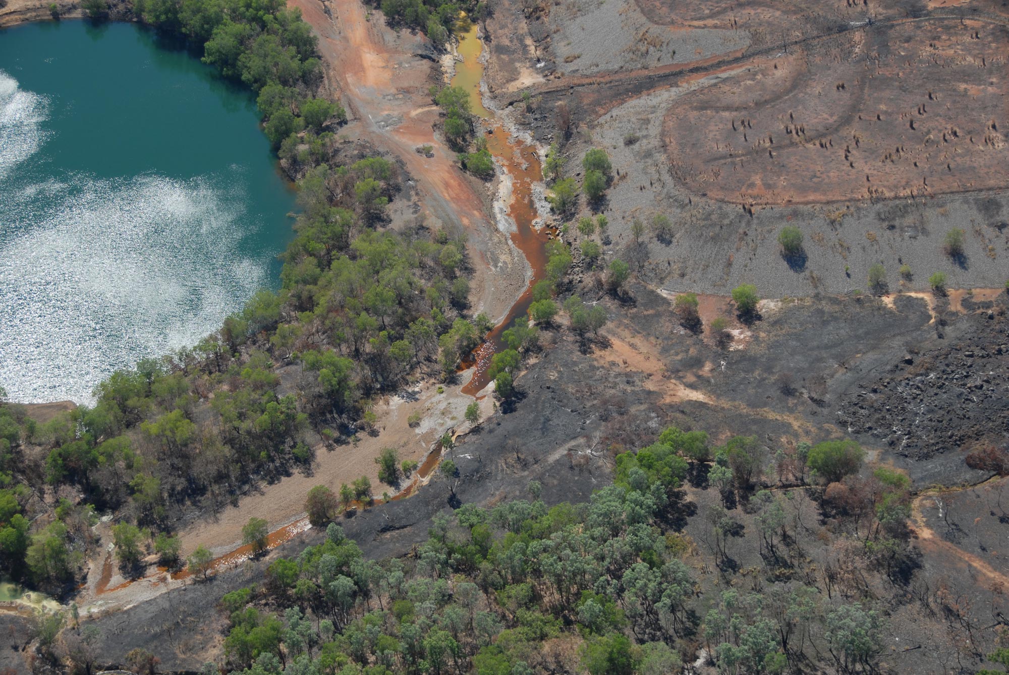 Pollution seeping from Rum Jungle uranium mine material, near the Finniss River.