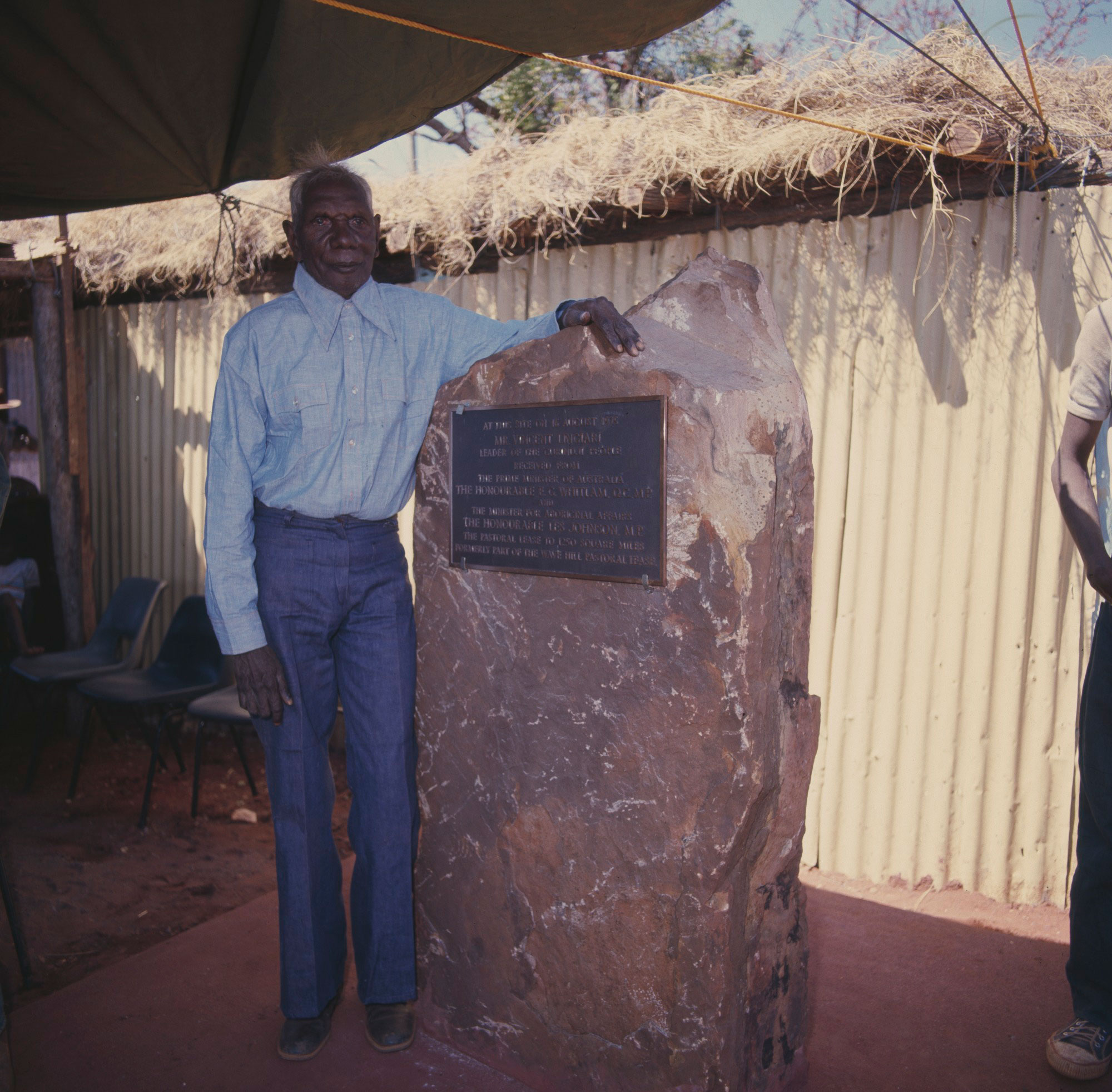 Vincent Lingiari beside a plaque marking the handing over of the lease, in Wattie Creek, Northern Territory, 16 August 1975.