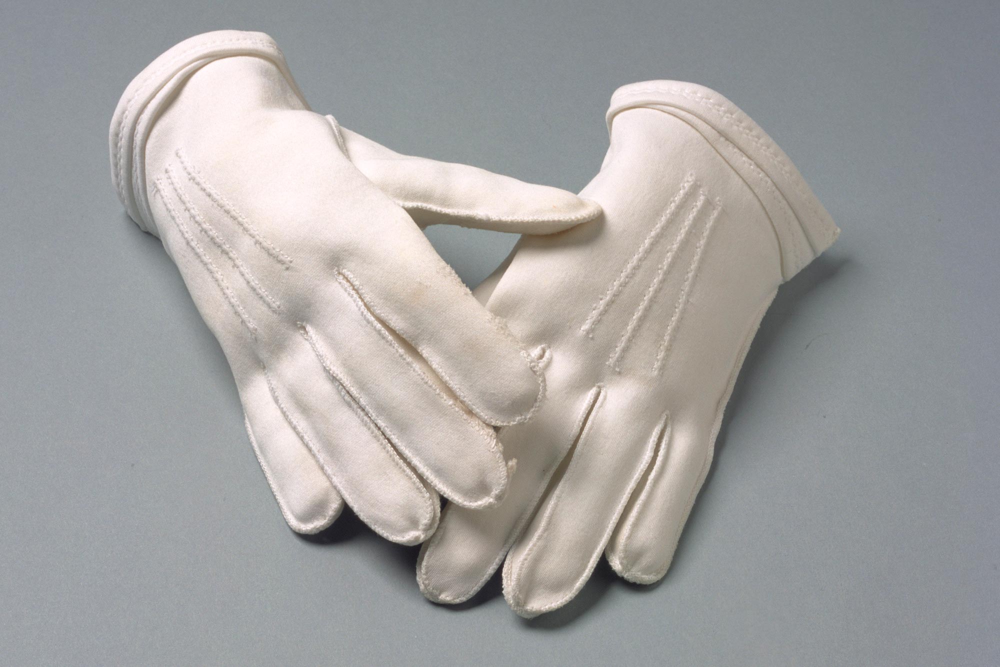 Pair of short white cotton gloves worn by Aboriginal rights activist Faith Bandler.
