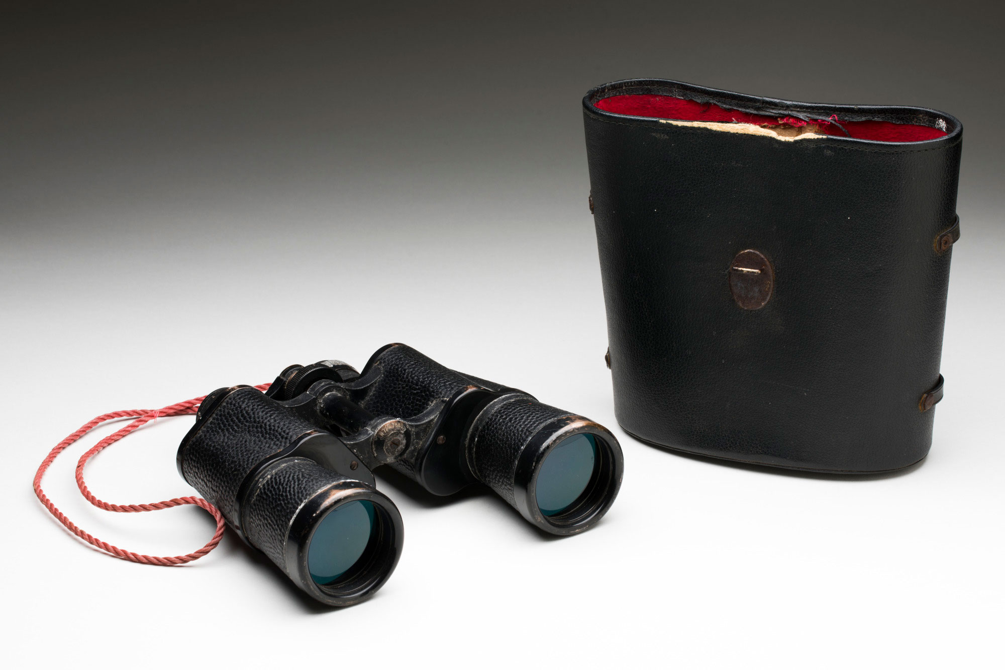 <p>Black battered Russian-made binoculars used on the fishing and refugee boat <em>Hong Hai</em></p>
