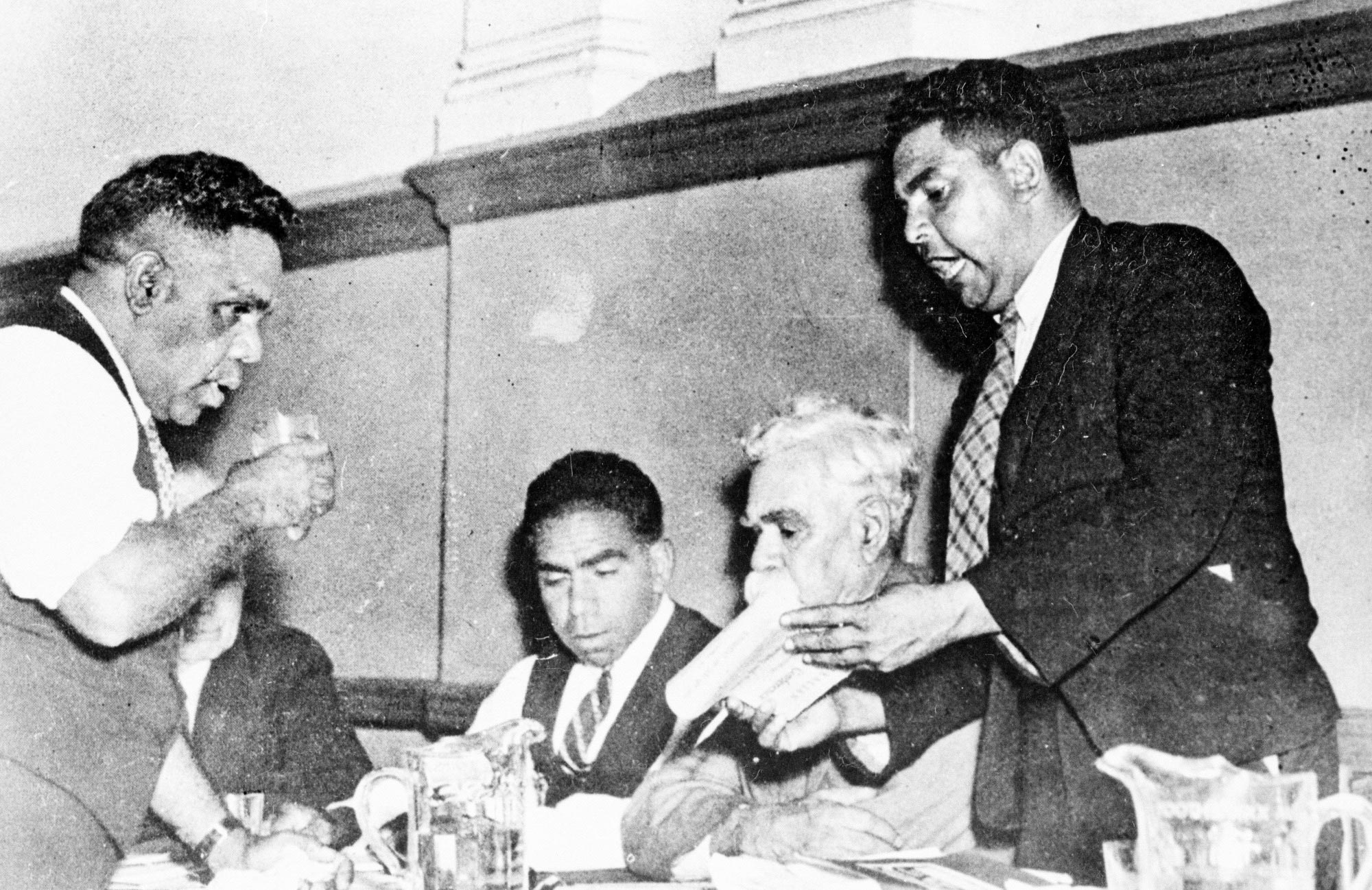 Aboriginal rights activists Tom Foster, Jack Kinchela, Douglas Nicholls, William Cooper and John Patten discuss a resolution, 1938.