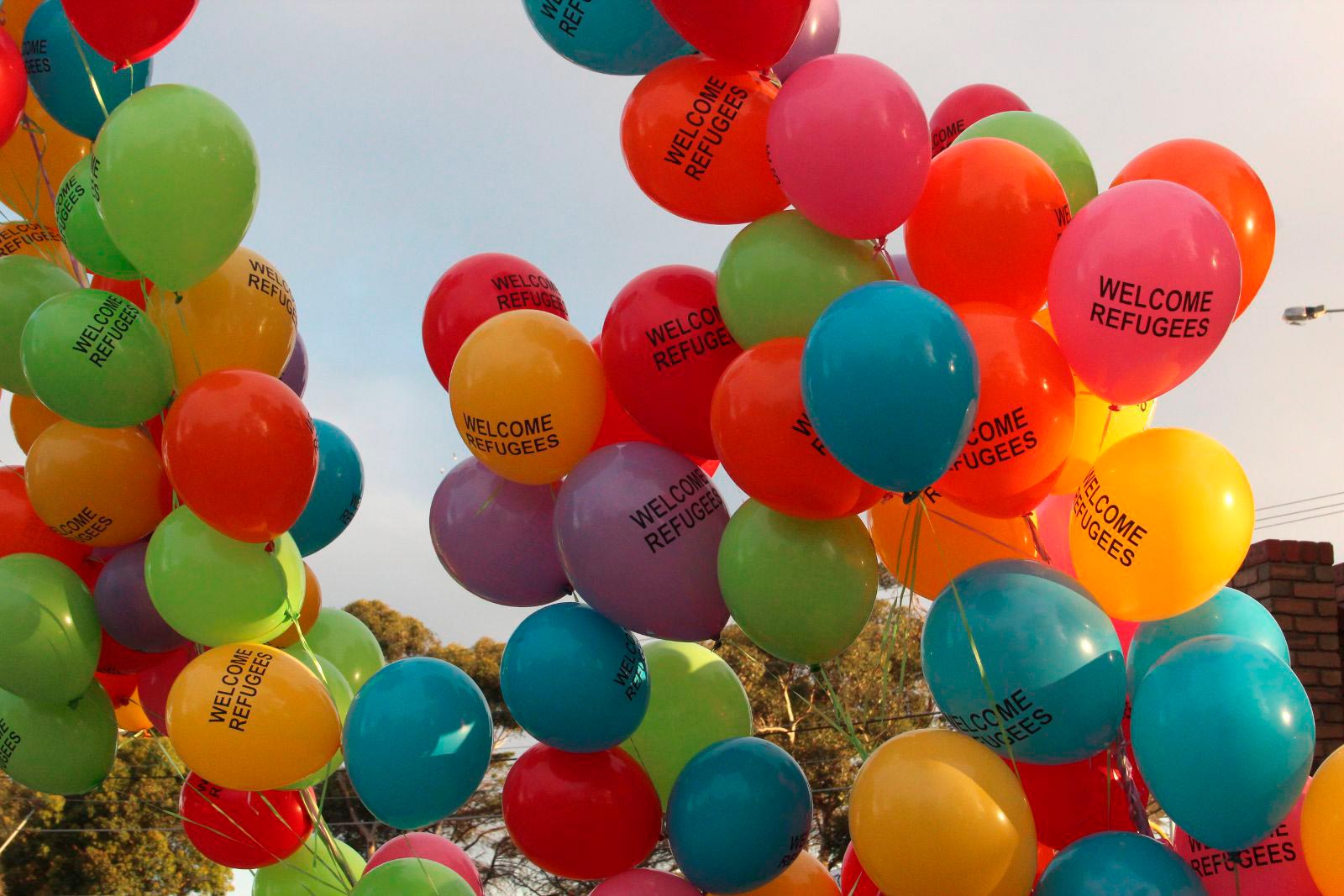 Balloons printed with a message of support for refugees.