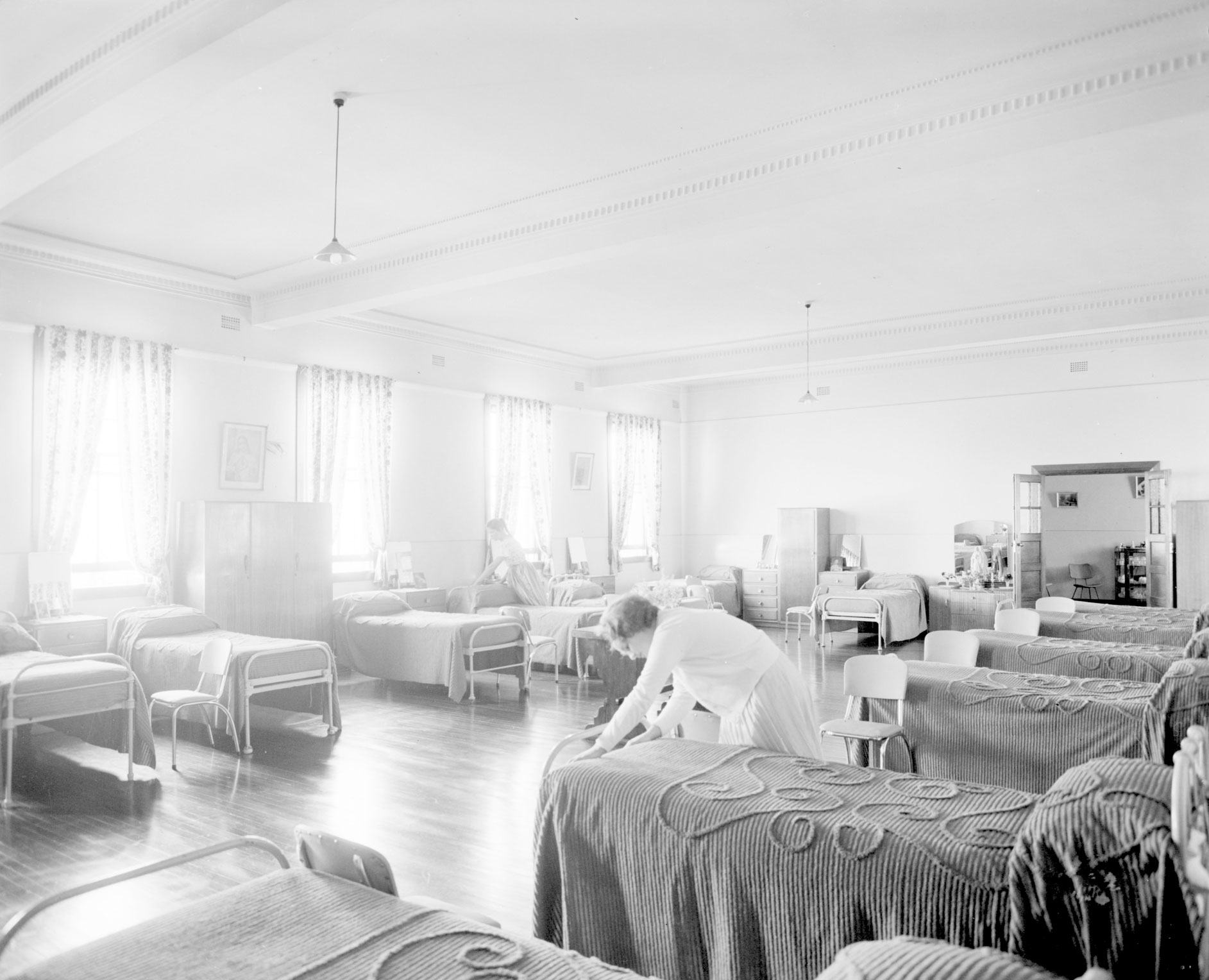 A girl making a bed in a dormitory. Home of the Good Shepherd girls’ home, Ashfield, 8 October 1963 [picture] / John Mulligan.