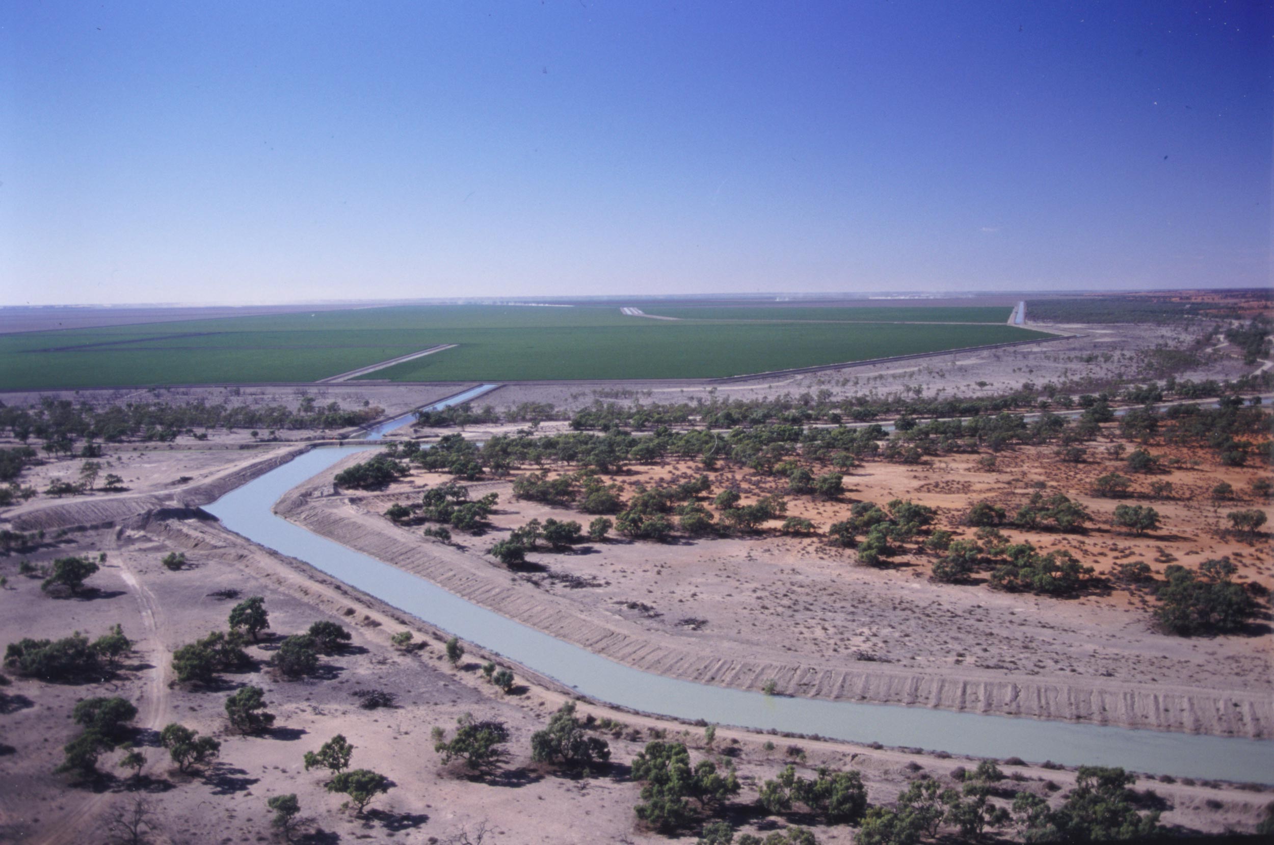 Irrigation canal and cotton fields at Tandou farm, Menindee, New South Wales, about 1995.