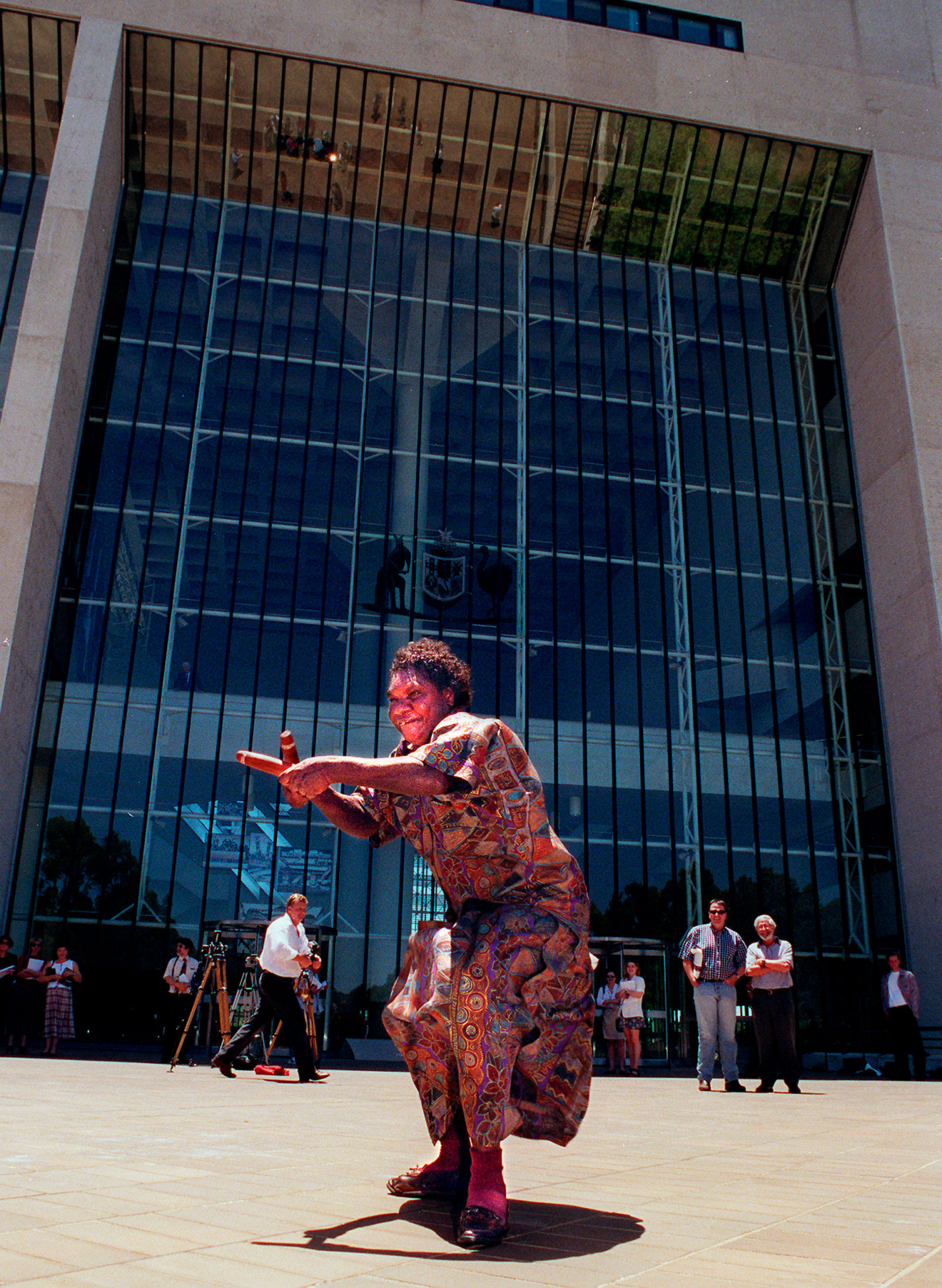 Aurukun Elder Gladys Tybingoompa dances on the steps of the High Court, which had just ruled in favour of the Wik native title claim, 1996