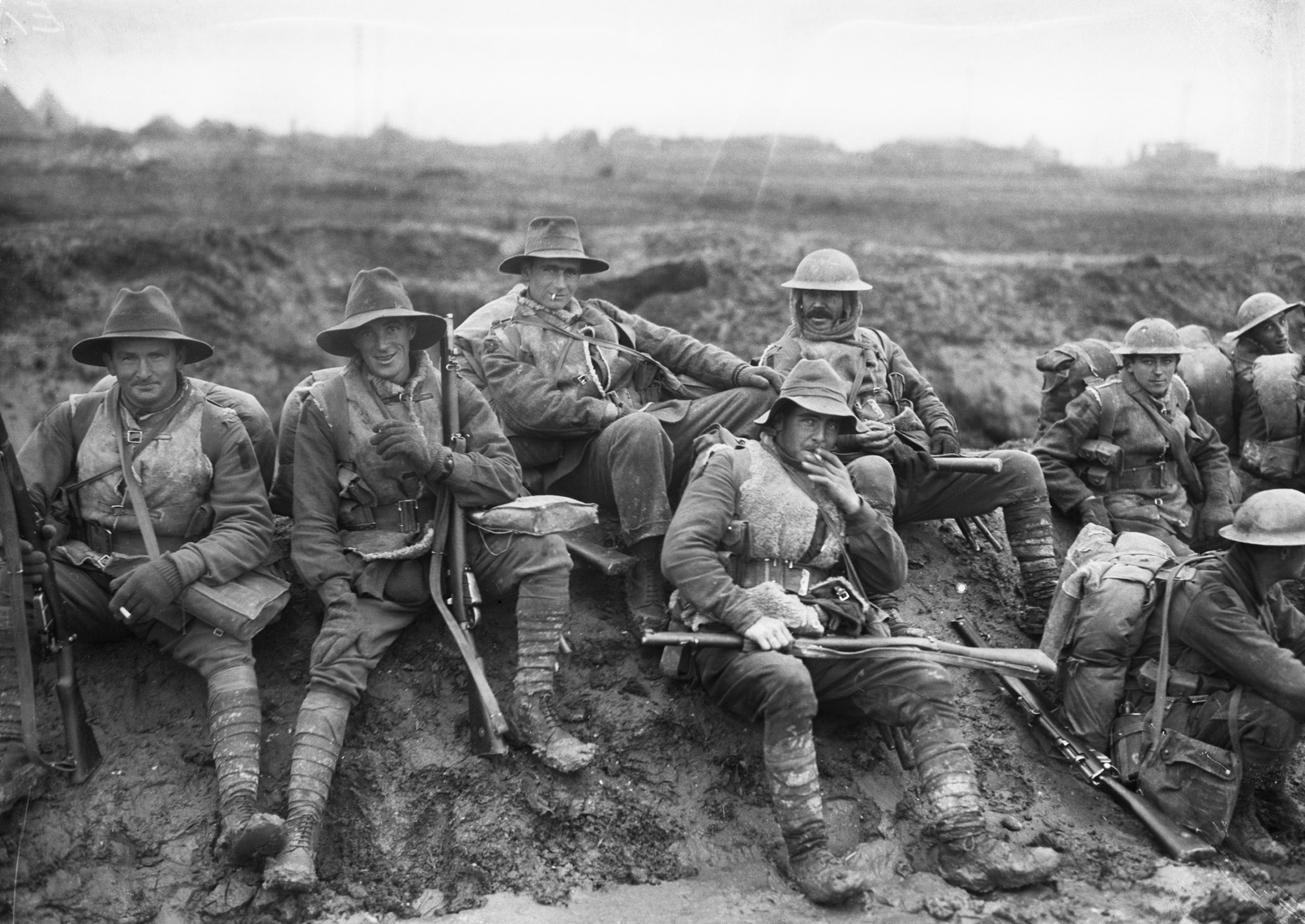 Unidentified men of the 5th Division resting by the side of the Montauban road, near Mametz, while enroute to the trenches, December 1916