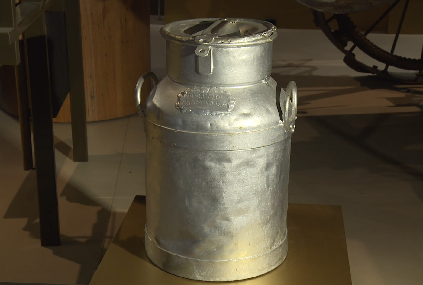 A metal milk storage can.
