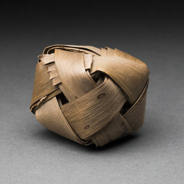 A toy ball woven from coconut palm leaves.
