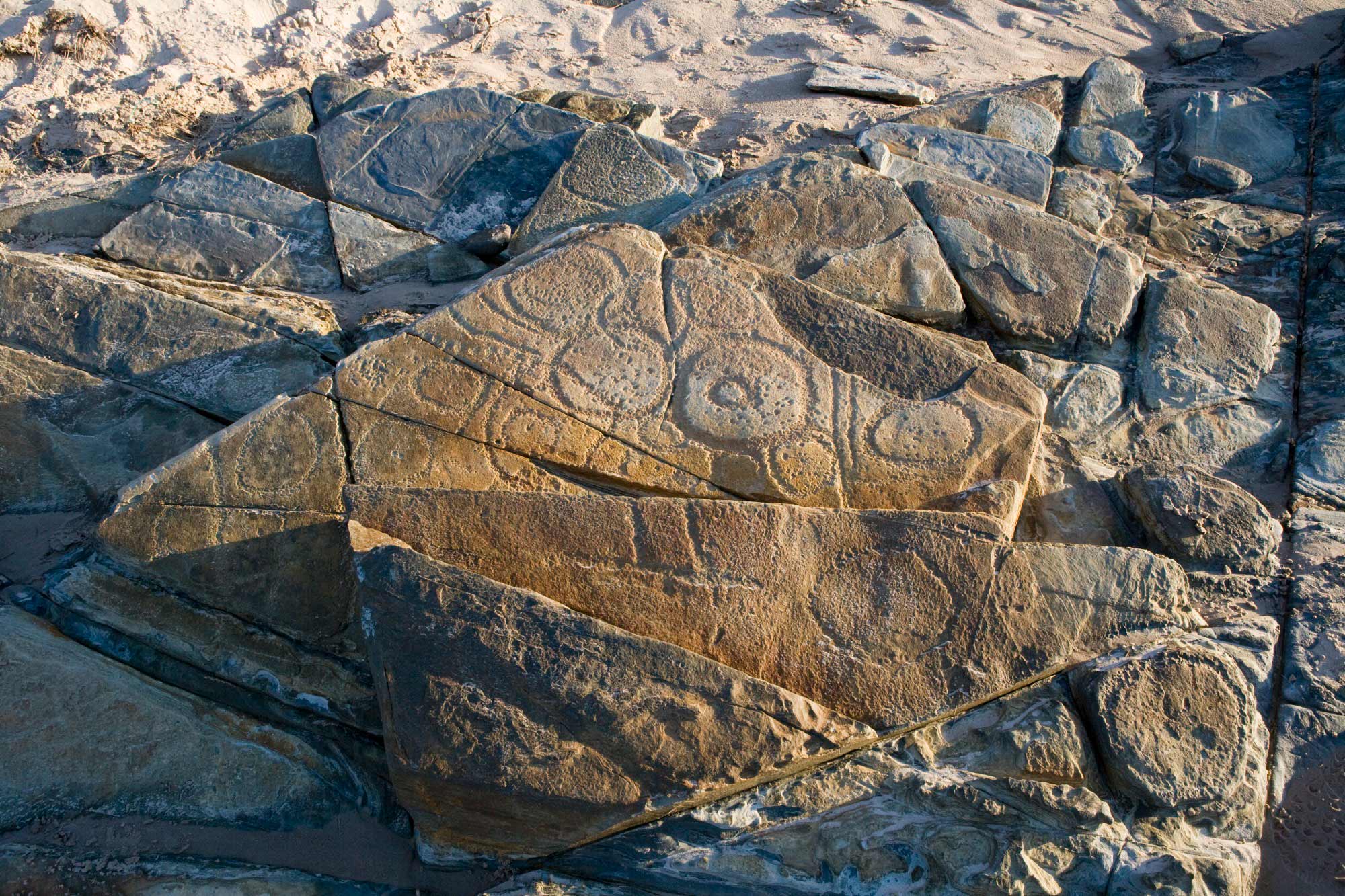 Rock formation with incised design.