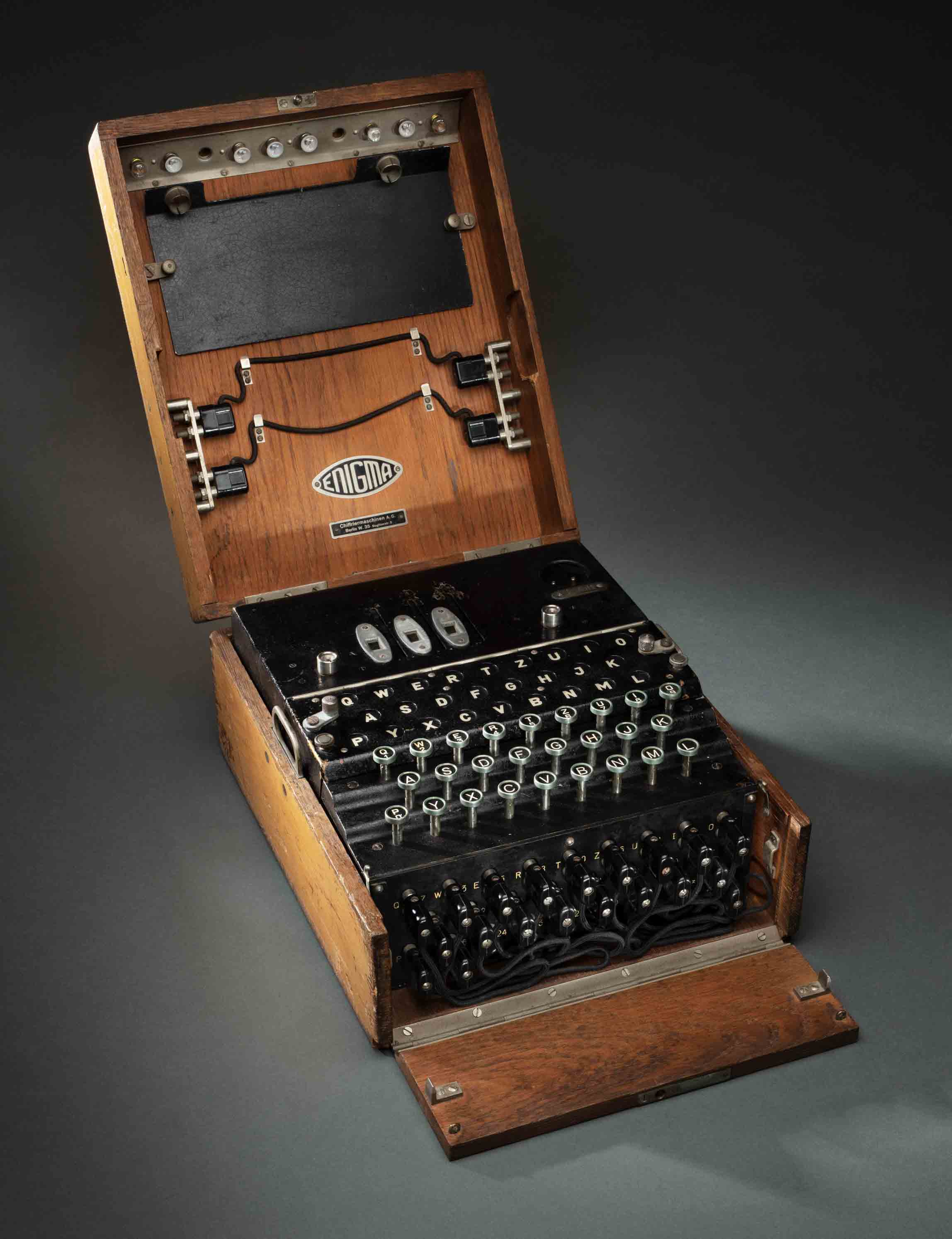 Cipher machine with rotors and metal typewriter keys in a timber box.