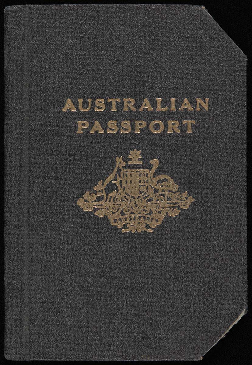 Australian passport with black vinyl cover. In gold in the middle of the front cover is the title "AUSTRALIAN PASSPORT" above the Australian coat-of-arms. The corners of the cover and pages have been clipped.