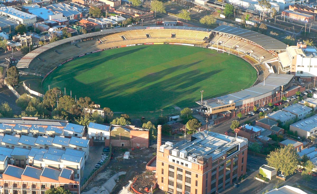 Aerial view of a sports ground surrounded by buildings.
