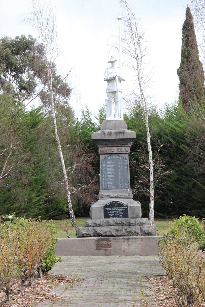 Park memorial featuring a statue of an Australian soldier at the top. Below is a plaque titled 'THE FALLEN' with a list of names below.