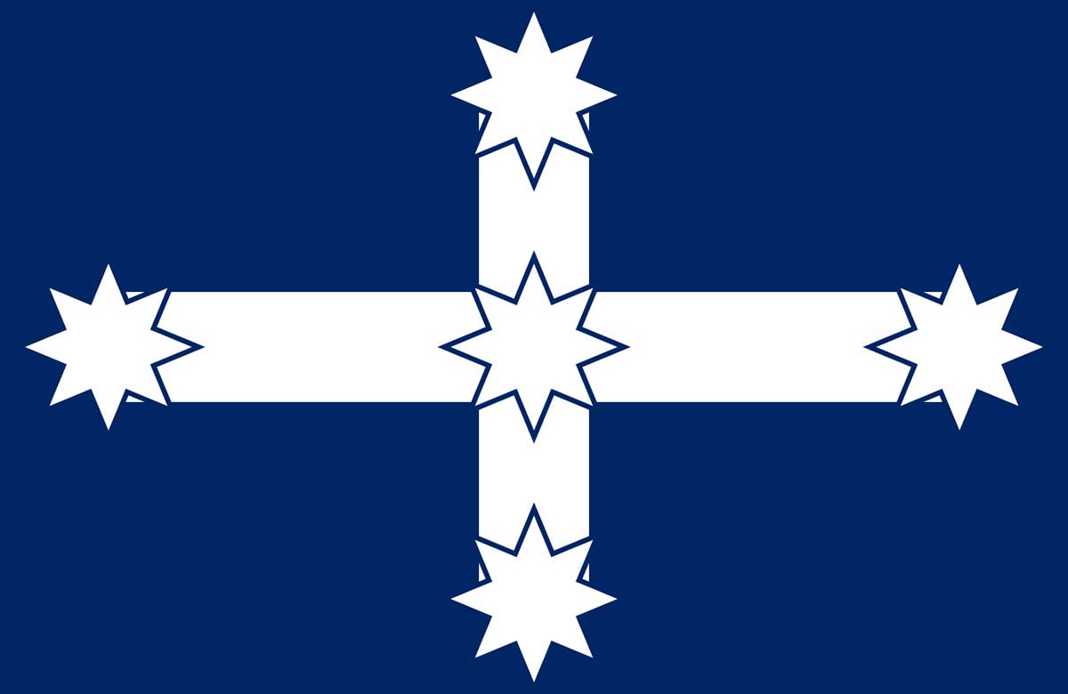 Flag featuring a white cross with star shapes on the ends and centre, against a blue background.