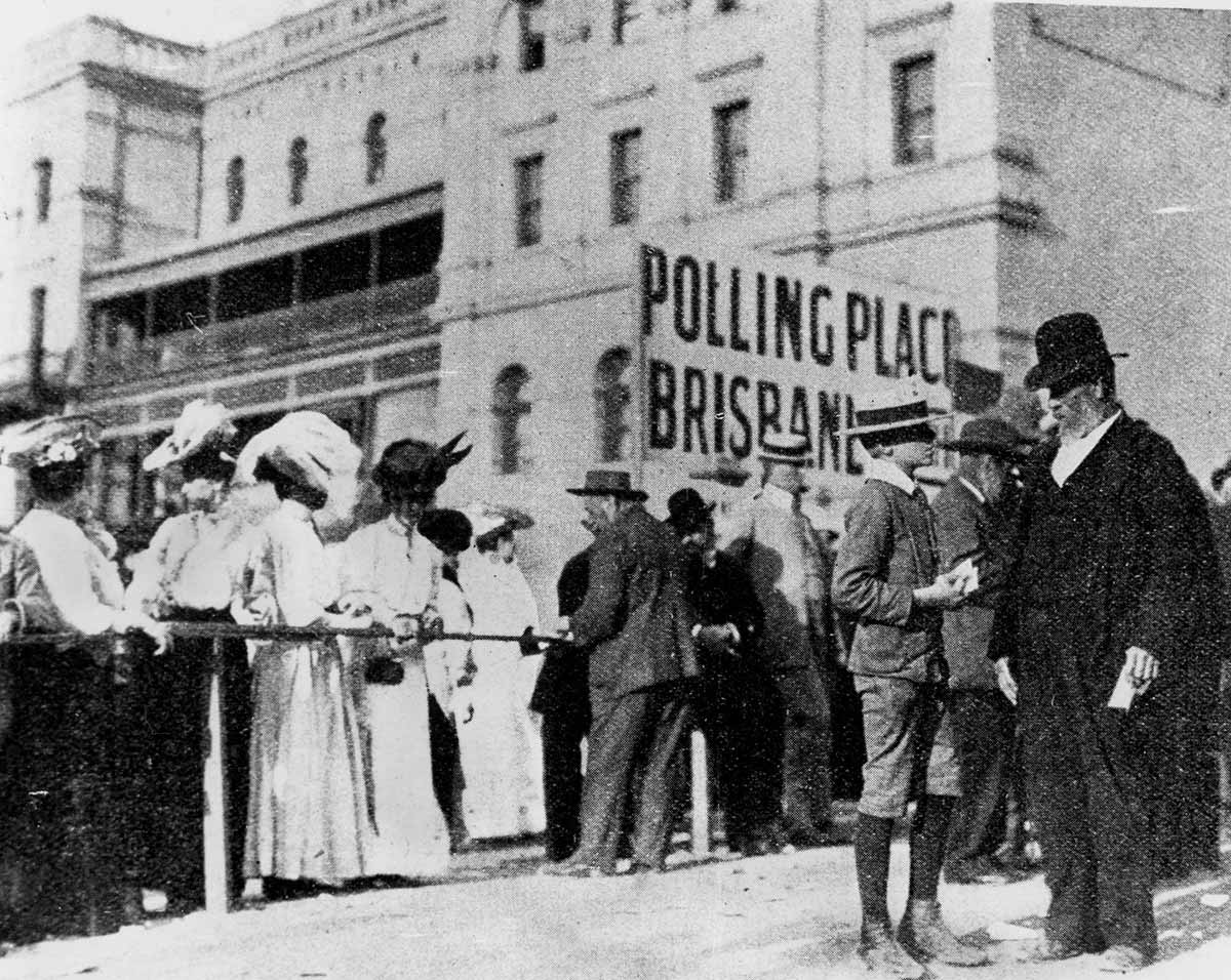 Black and white photograph of a crowd of people outside a polling place in Brisbane.
