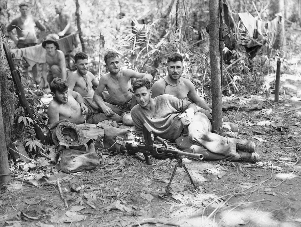 Men of the 2/31st Australian Infantry Battalion stop for a rest in the jungle between Nauro and Menari, but do not leave their .303 Bren Mark 1 light machine gun too far away. Papua New Guinea, 1942.
