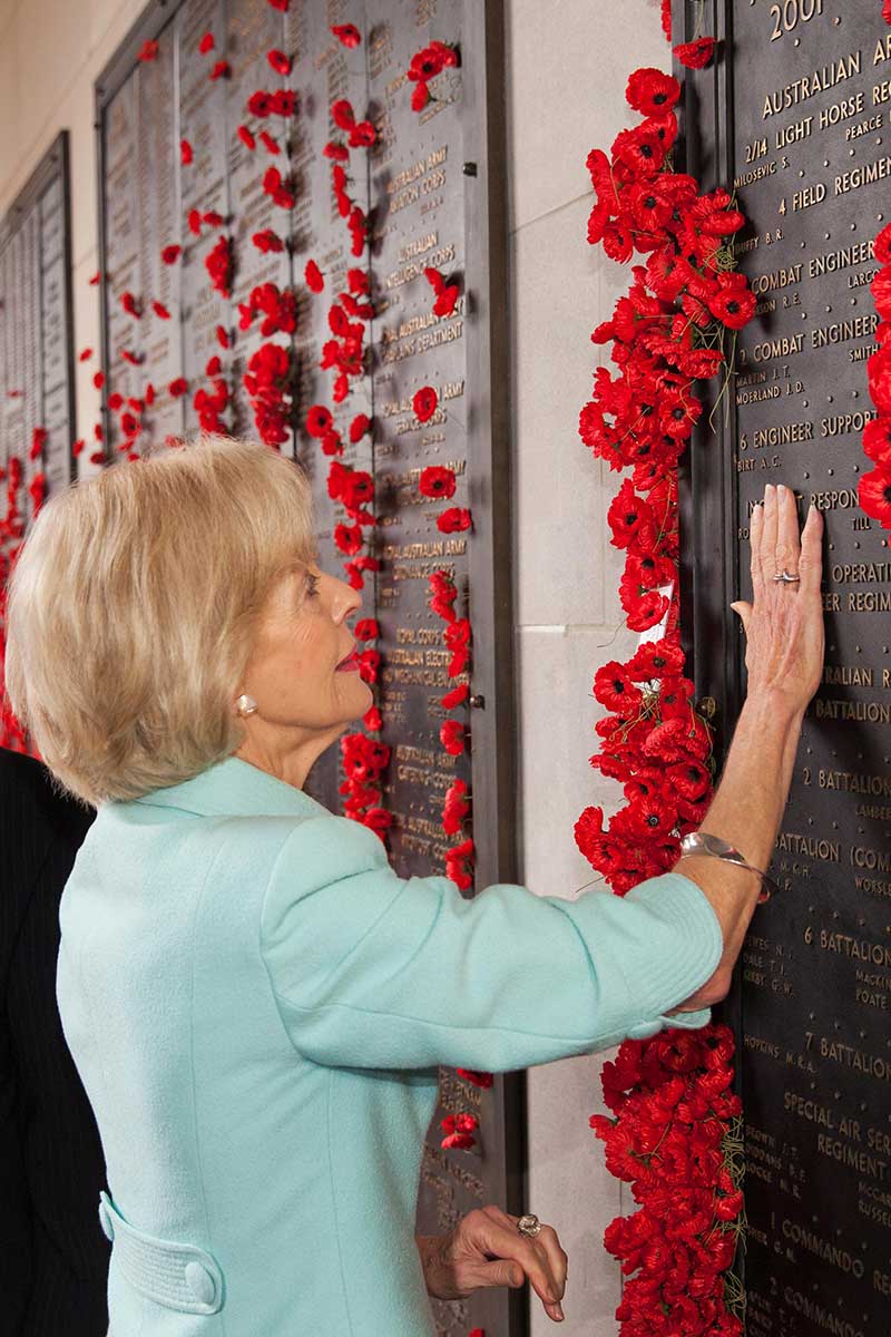Quentin Bryce places her hand on a commemorative plaque at the Australian War Memorial.