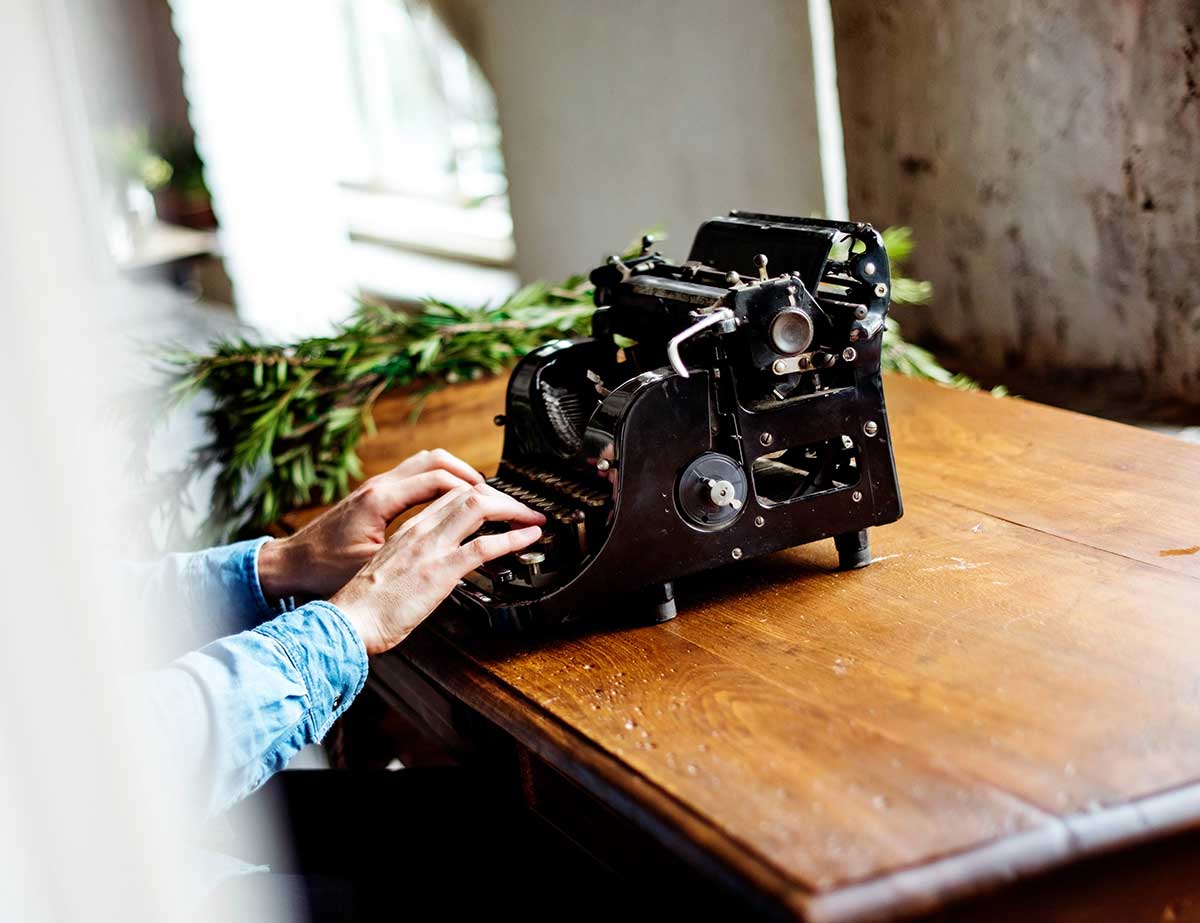 Hands using a typewriter.