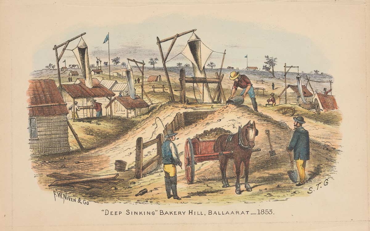 A series of huts with gerry-rigged frames from which are suspended what appear to be canvas chutes extending down into holes in the ground. In the foreground three men are working around a pony and cart, which is filled with soil.