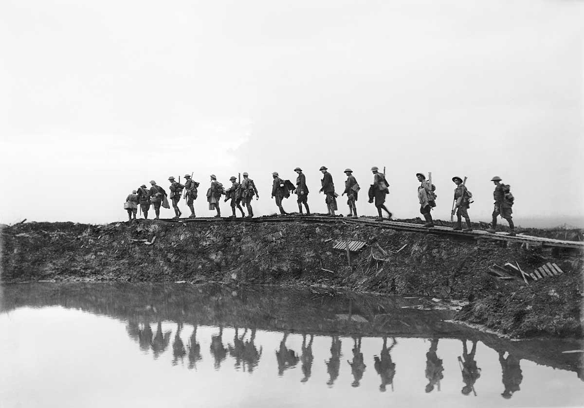 <p>Supporting troops of the 1st Australian Division walking on a duckboard track near Hooge, in the Ypres Sector, Belgium, 1917</p>