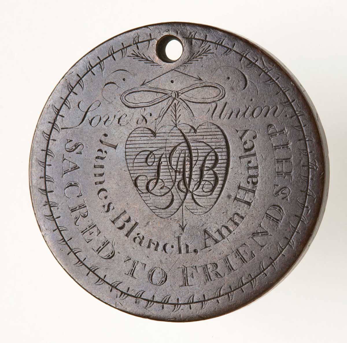 A convict love token made up of a coin engraved on one side. The engraved side features the text 'Love & Union / JAB / James Blanch / Ann Harley / SACRED TO FRIENDSHIP' around a design of two hearts joined by a ribbon.