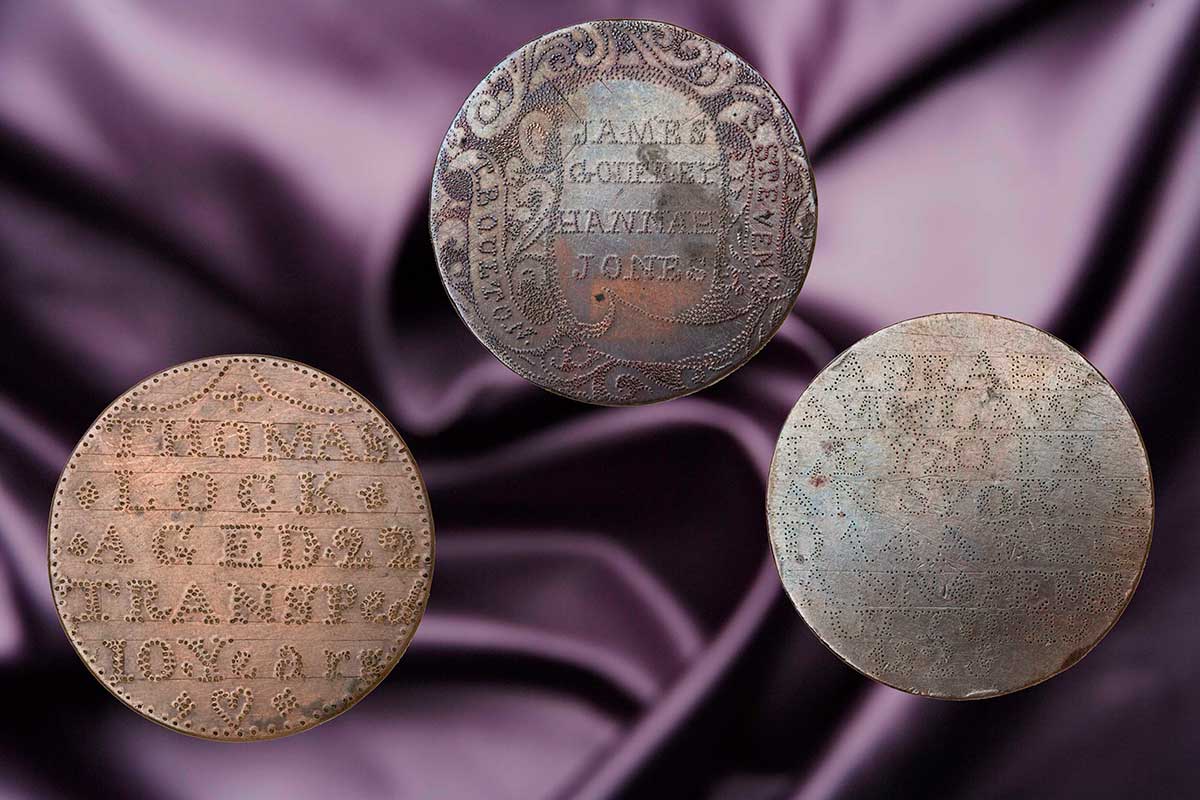 Three Three tokens in the form of circular copper discs stipple-engraved with decorative details and text.