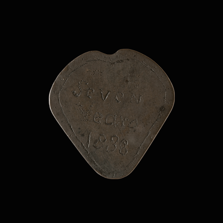 Token shaped into a rough heart shape, crudely engraved with a border and printed text:  Seven  Years  1838  Token shaped into a rough heart shape, crudely engraved with a stippled border and printed text:  J . M  Oct  22 