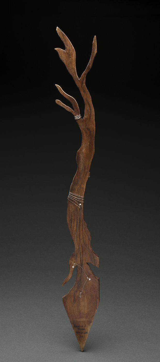 Wik stick artwork carved into a tree shape.