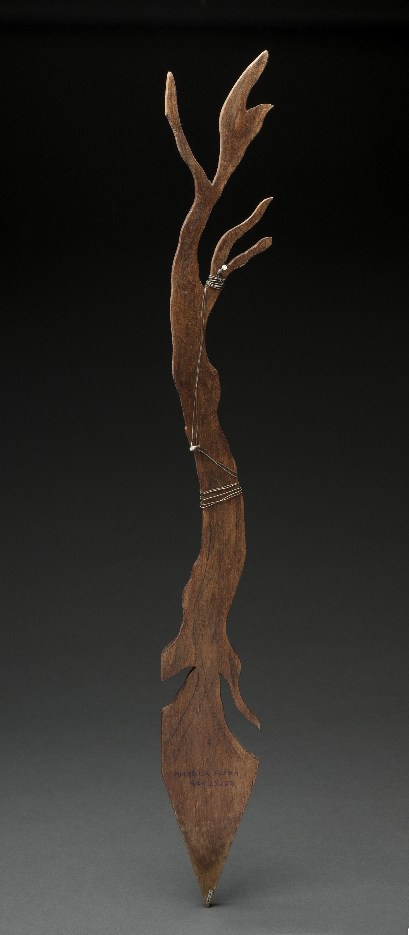 Wik stick artwork carved into a tree shape.