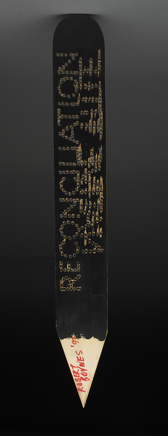 A large pencil type wik stick artwork with reconciliation written on it.