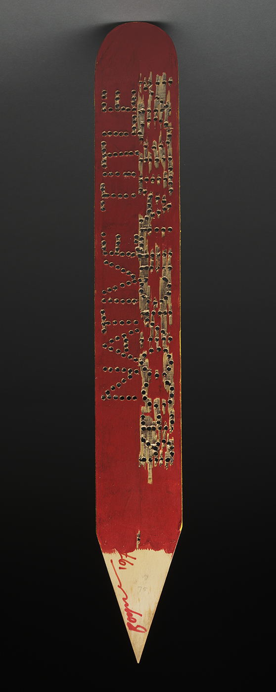 A large pencil type wik stick artwork with native title reconciliation written on it.