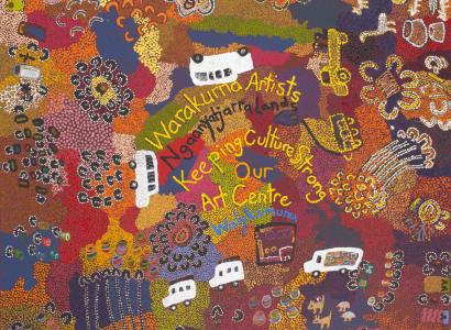 A multi-coloured dot painting with three motor vehicles painted in white in the centre and another two in yellow dots on the right hand side. 'Warakurna Artists/ Ngaanyatjarra Lands / Keeping Culture Strong / Our / Art Centre' is written in the central section.