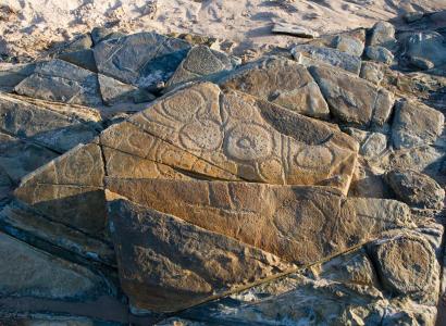 Rock formation with incised design.