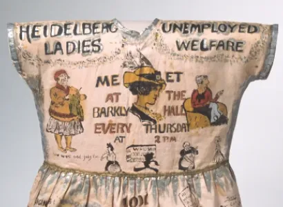 'Heidelberg Dress' – girl's fancy dress garment, hand-painted with cartoons and caricatures showing the work of the Heidelberg Unemployment Bureau, 1932.
