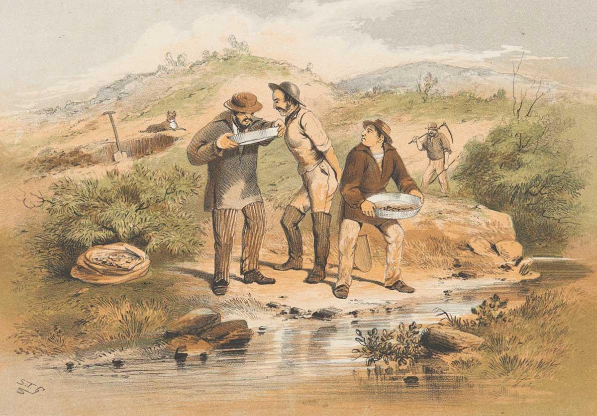 Three men stand by a stream. Two are looking into a gold pan. In the background is a hole with a shovel in it, and a man carrying a hoe.